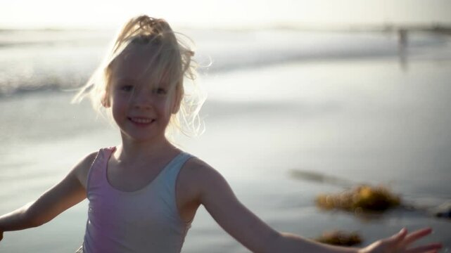 Joyful Child Jumping on Beach at Sunset