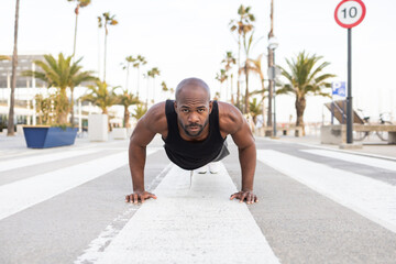 Cuban Man Exercising Outdoors with Push ups on a City Street