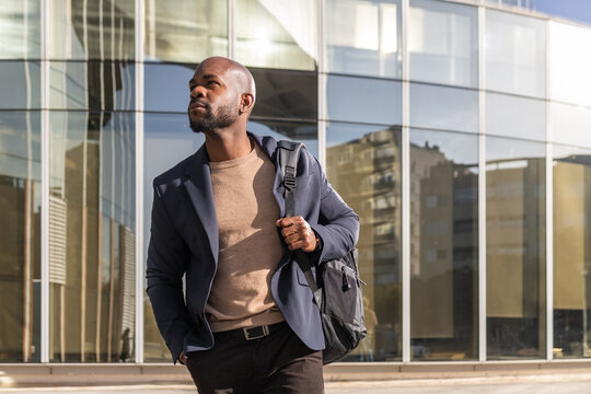Professional cuban man walking confidently in urban setting