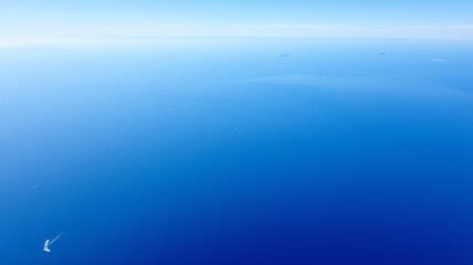 The ocean stretches out endlessly beneath the plane