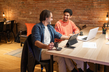 Collaborative Workspace with Laptops and Coffee Break