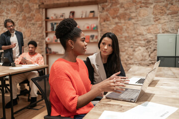 Collaborative team working in modern coworking space