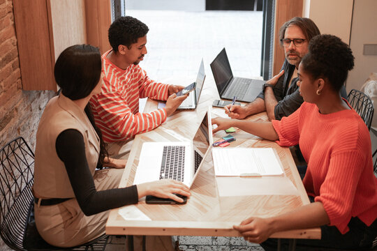 Collaborative workspace with diverse professionals sharing ideas