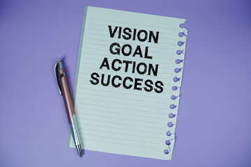 Vision Goal Action Success text written on paper with pen on purple background