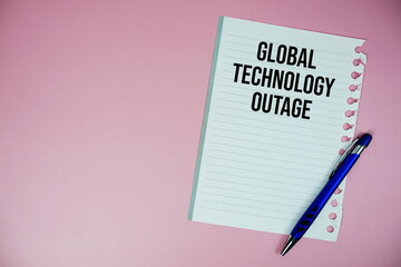 Global Technology Outage text written on paper with pen on pink background