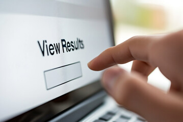 close-up of a student's finger hovering over the "View Results" button on a website.