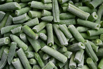 frozen Asparagus beans cut, macro green beans, green frozen asparagus beans as background photo from above 