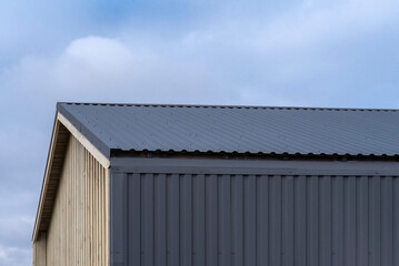 Building with a corrugated roof and vertical siding