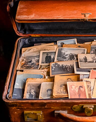 Lots of vintage photos in an old suitcase. Old photos