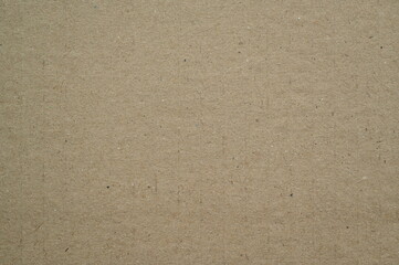 grey kraft paper texture background. Natural brown cardboard surface with fine fibers and recycled material look. Eco-friendly packaging and design concept.