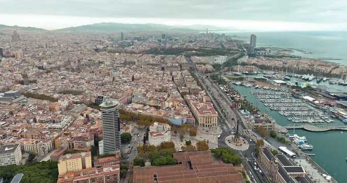 Aerial view of the architecture of the Barcelona embankment cityscape. Urban landscape of downtown houses and the Mediterranean Sea in Catalonia. High quality 4k footage