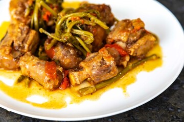 Traditional beef oxtail with watercress, a rustic Brazilian dish