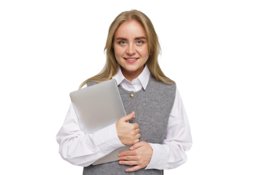 Young woman smiling while holding a laptop under her arm in a professional setting with casual attire