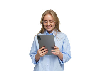 Fototapeta premium Young woman in blue shirt smiles while using tablet device in bright indoor setting