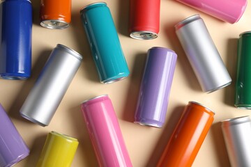 Many tin cans on beige background, flat lay