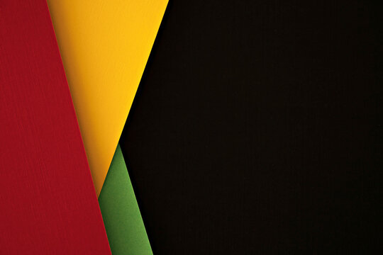 Abstract geometric black, red, yellow, green color background. Colorful papercut layout background