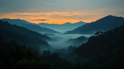 Mountain range with morning fog and golden sunrise colors