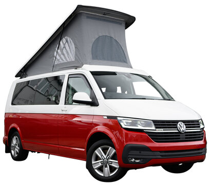 A red and white Volkswagen van with a pop top roof