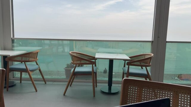 A co-working place by the sea, suitable for IT and digital nomads. Bright room, large panoramic windows, laptop, cozy tables