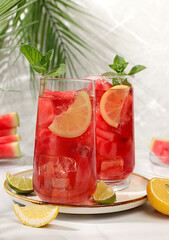 Refreshing summer drink recipeCold homemade lemonade or cocktail with mint, watermelon and fruits...
