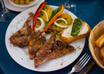 Baked under tasty lamb served with potatoes and bread at plate