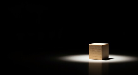Wooden block illuminated against a dark background creating a minimalistic atmosphere