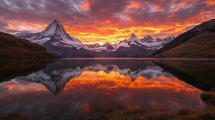 Fototapeta premium Mountain Peaks Reflected in Still Lake at Sunset