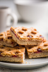 Sweet linzer cake on plate on kitchen table.