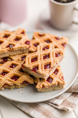 Sweet linzer cake on plate on kitchen table.