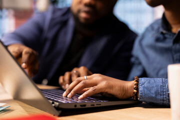 African American man and woman sits at a stylish home office, brainstorming ideas for their digital business, using modern technology to improve communication and project efficiency.