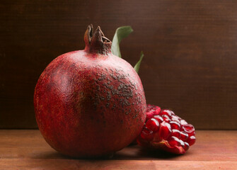whole pomegranate on wooden background
