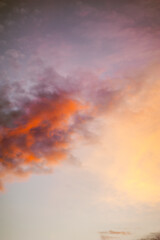orange clouds of unusual shape against the blue sunset sky