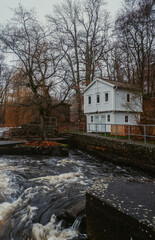 Historic white wooden traditional swedish house cottage by a rushing river in Mörrum, Skåne, Sweden. Countryside in Sweden.
