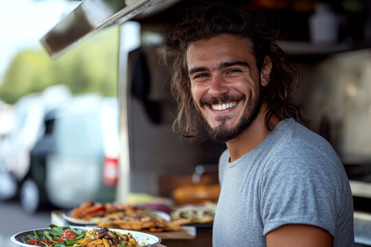 Smiling man with long hair stands near a food truck serving colorful dishes on plates. Concept of food service and outdoor dining. For food truck photography - Powered by Adobe