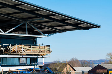 Fototapeta premium Construction site with stacked materials under clear blue sky