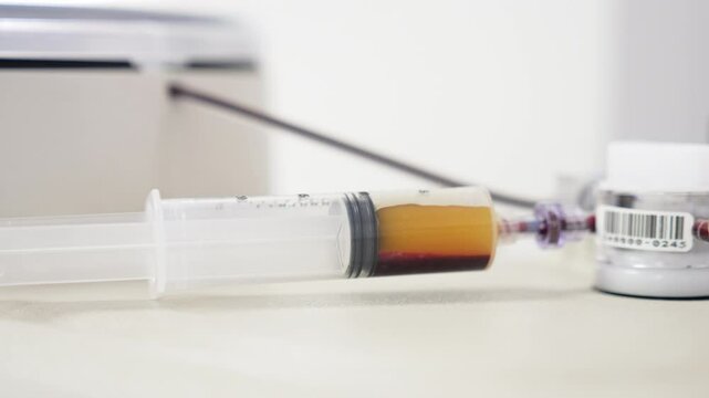 Syringe is half-filled with plasma. Preparation for PRP therapy. Close up.