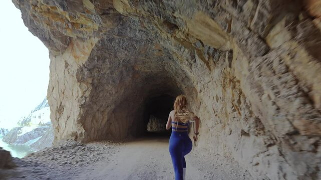 Female Athlete Running Towards Victory on Canyon Path