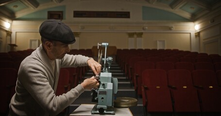 The Film Projectionist is working diligently in an Empty Theater, showcasing skills and passion