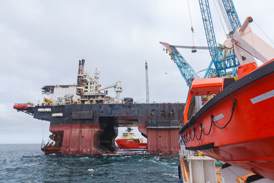 An offshore oil platform serviced by offshore supply vessels.