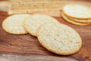 Assorted Whole Grain and Herb Crackers on a Wooden Cutting Board