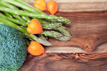 Fresh vegetables with habanero peppers and tomatillos on a rustic wooden surface