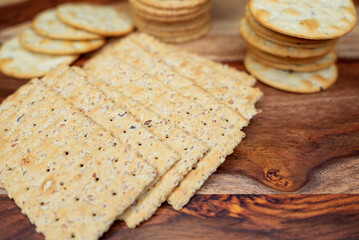 Assorted Whole Grain and Herb Crackers on a Wooden Cutting Board