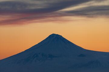 Small Mount Ararat (Sis), the national symbol of Armenia, seen during a cold winter sunset with a colorful sky. The snow-covered peak stands tall, located in present-day Turkey