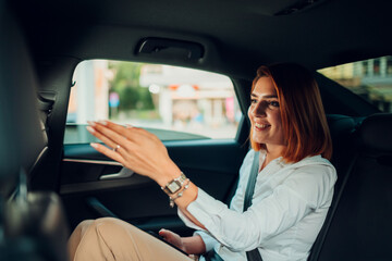 Businesswoman engaging in car conversation during ride