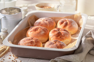 Hot and homemade golden kaiser rolls baked in the bakery.