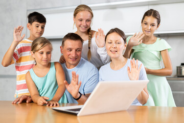 Big family meeting together at home kitchen for making video call