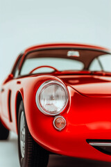 A red car with a smiling face on the hood
