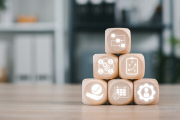 Wooden blocks with digital icons representing workflow and productivity in a modern business...