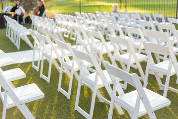 White chairs for an outdoor wedding