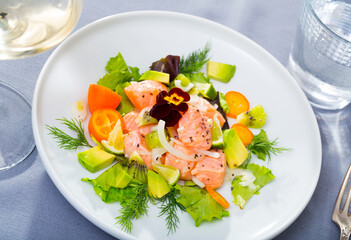 Close up of tasty seafood ceviche from salmon with avocado, green dill and cumquat